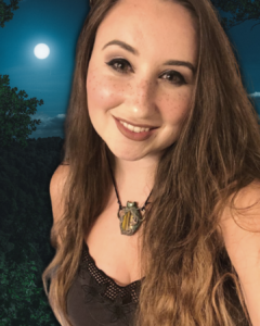 Panthera, the Feralwood Witch, smiling at camera with a moon in the background